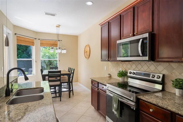 a kitchen with stainless steel appliances granite countertop a sink and cabinets