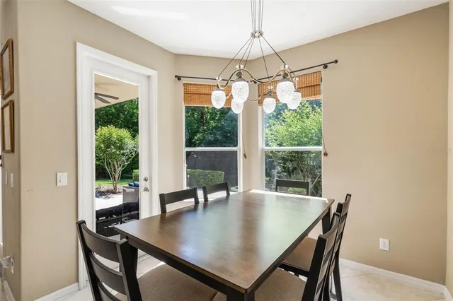 a view of a dining room with a table and chairs