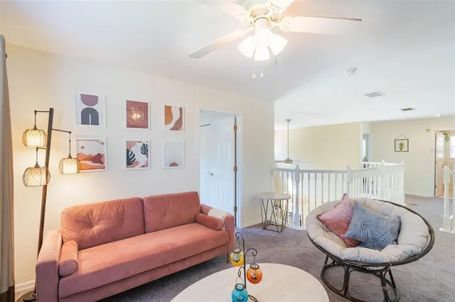 a living room with furniture and a chandelier