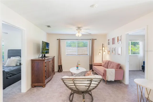 a living room with furniture and a chandelier