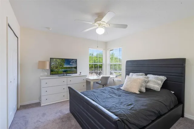 a bedroom with a bed and a flat screen tv