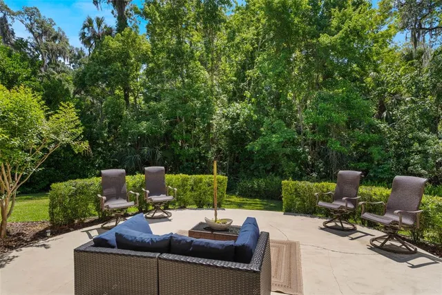a view of a backyard with sitting area