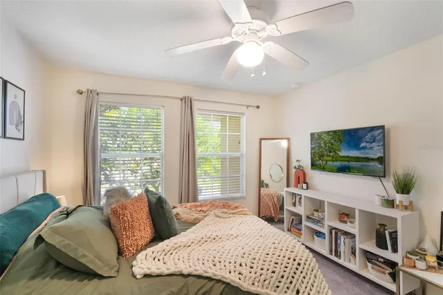 a bedroom with furniture and a flat screen tv
