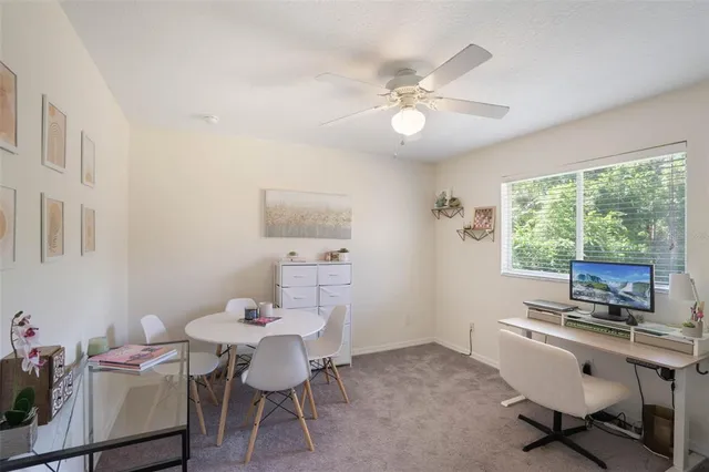 a view of a workspace with furniture and a window