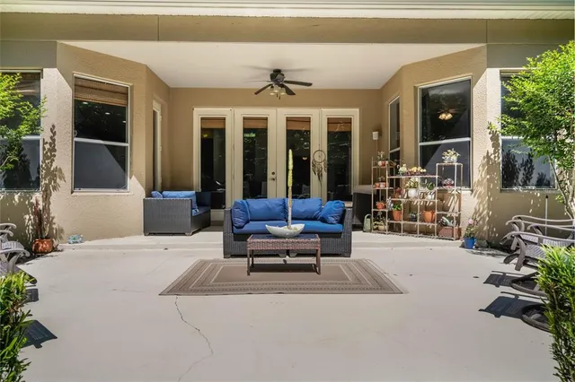 a building outdoor space with patio furniture and potted plants