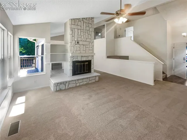 a view of a livingroom with furniture and chandelier fan