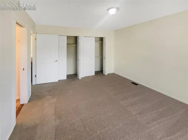 a bathroom with a granite countertop toilet sink and mirror