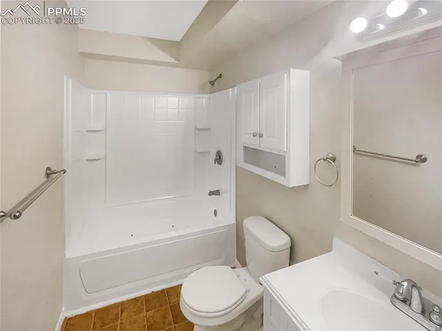 an empty room with closet and windows