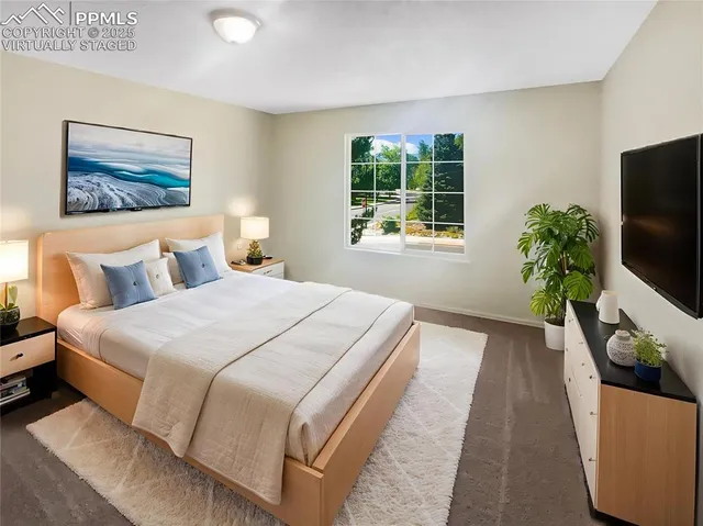 a bedroom with bed and a potted plant