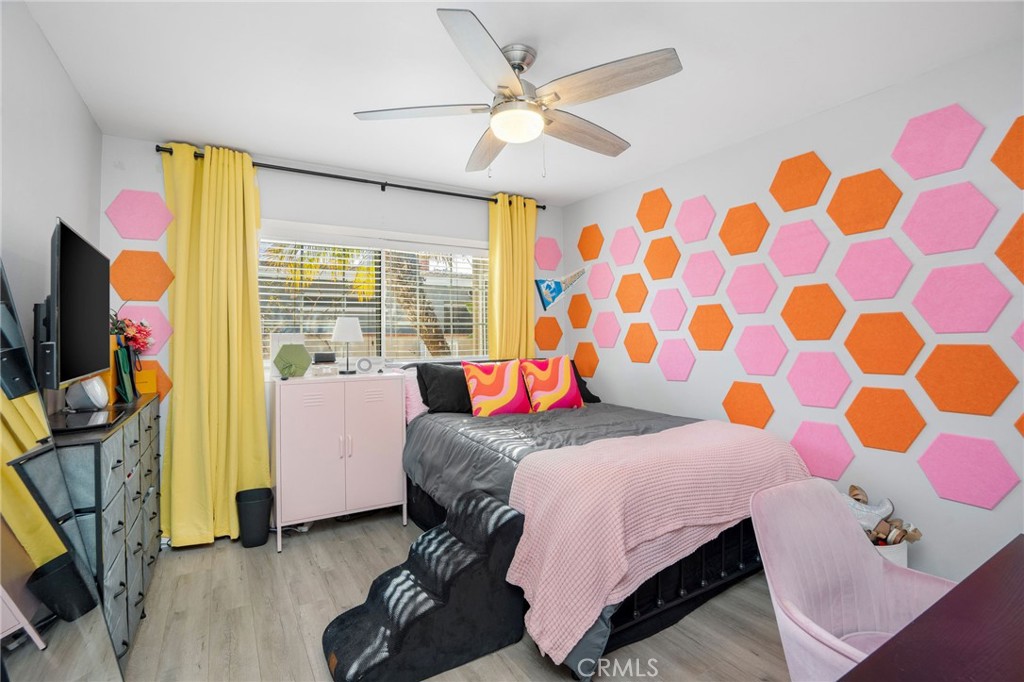 257 5th Street Seal Beach, CA 90740 - Photo 12 of 49 a bedroom with a bed flat screen tv and a window