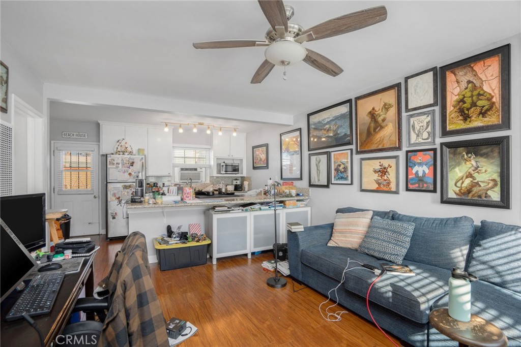 257 5th Street Seal Beach, CA 90740 - Photo 15 of 49 a living room with furniture a flat screen tv and a window