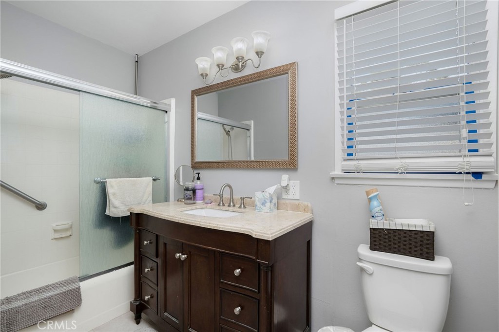 257 5th Street Seal Beach, CA 90740 - Photo 30 of 49 a bathroom with a sink vanity and a mirror