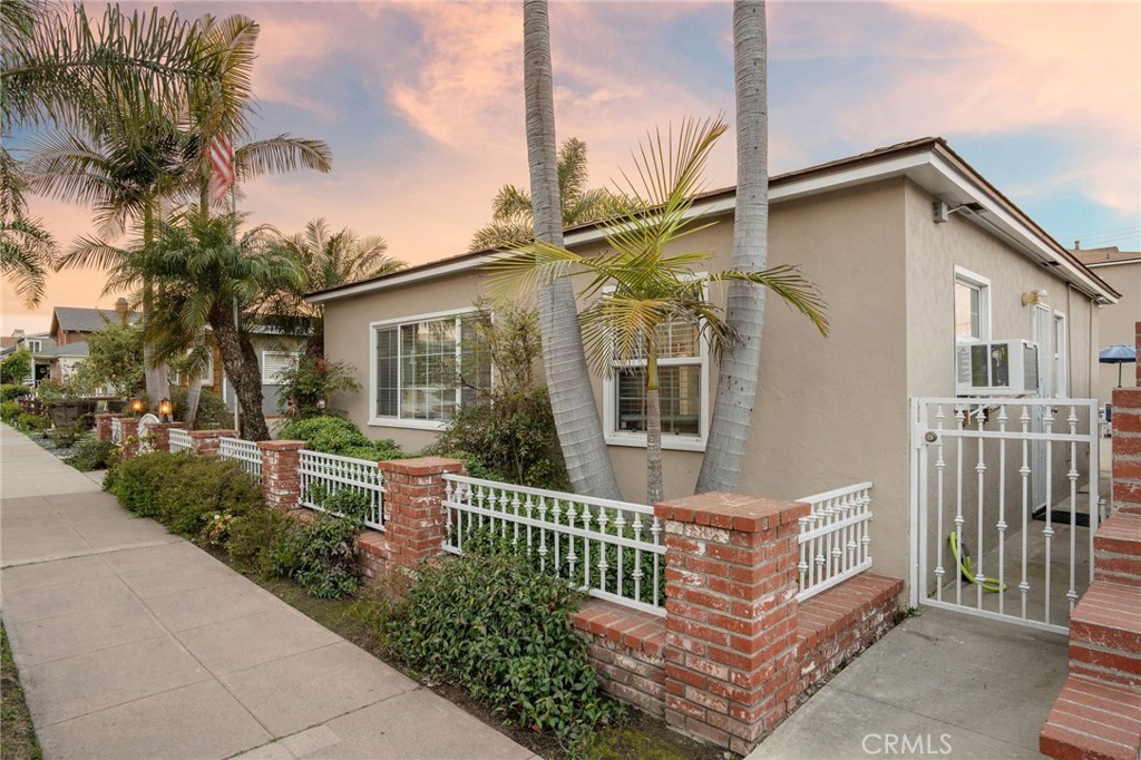257 5th Street Seal Beach, CA 90740 - Photo 3 of 49 a front view of a house with a garden