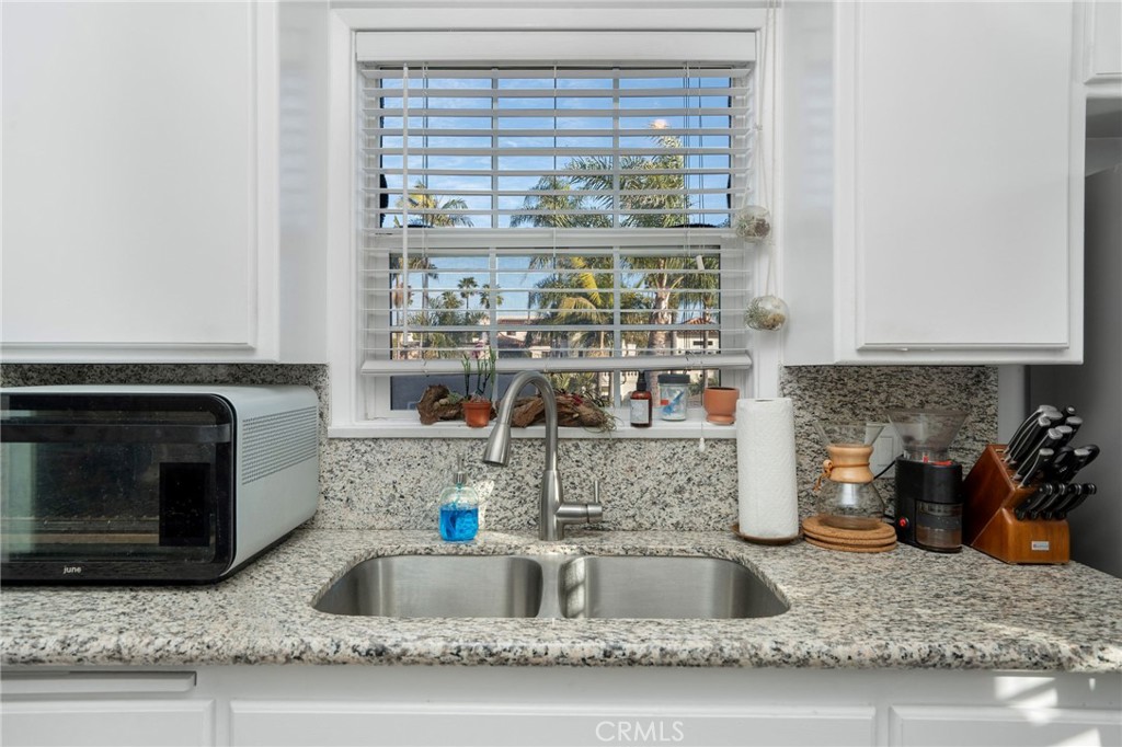 257 5th Street Seal Beach, CA 90740 - Photo 35 of 49 a kitchen with a sink and a stove top oven