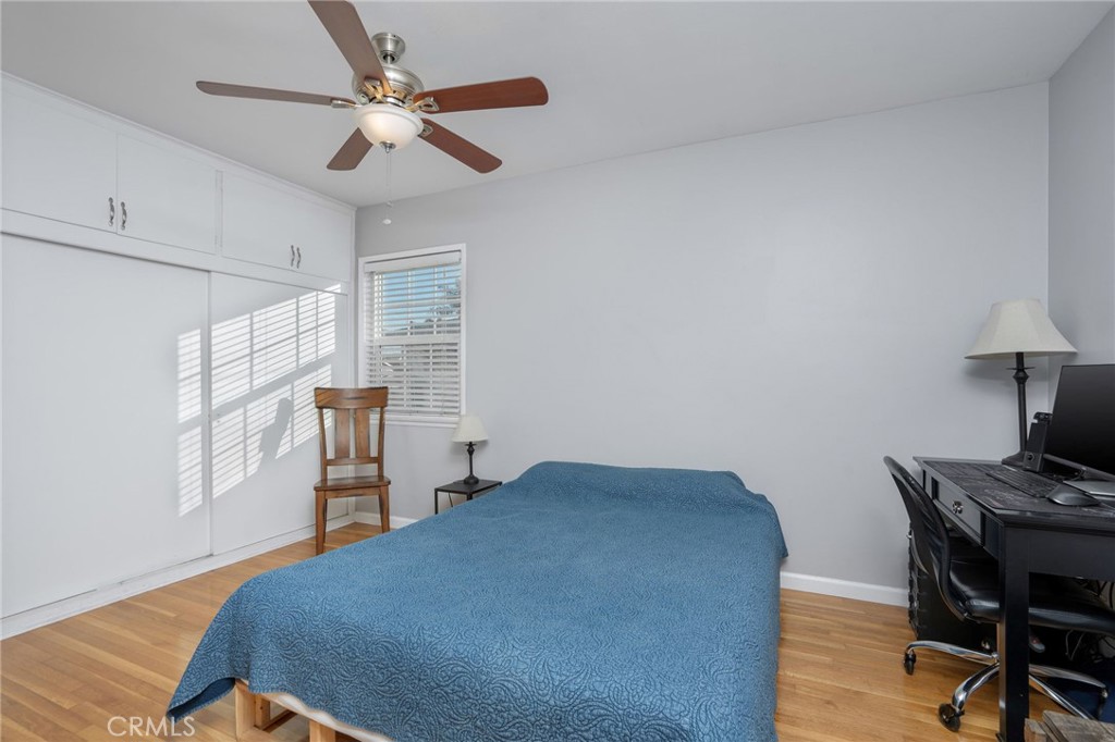 257 5th Street Seal Beach, CA 90740 - Photo 38 of 49 a bedroom with a bed and a desk