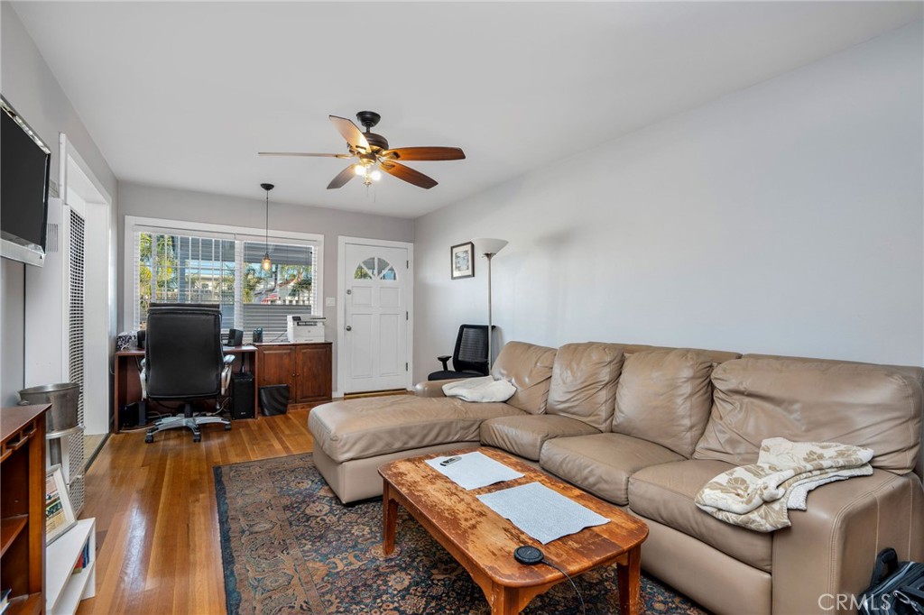 257 5th Street Seal Beach, CA 90740 - Photo 42 of 49 a living room with furniture a flat screen tv and a table