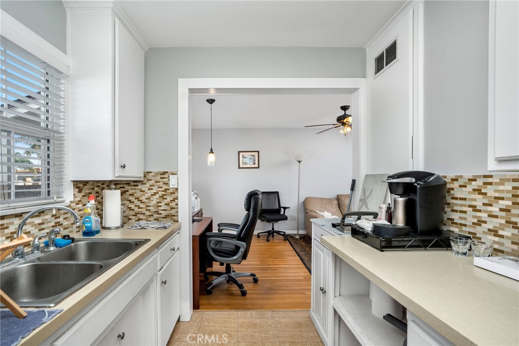 257 5th Street Seal Beach, CA 90740 - Photo 44 of 49 a kitchen with a sink and a stove top oven