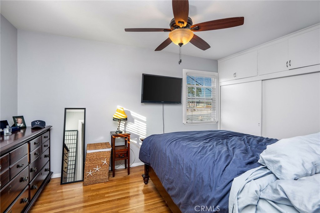 257 5th Street Seal Beach, CA 90740 - Photo 46 of 49 a bedroom with a bed and a flat tv screen on dresser