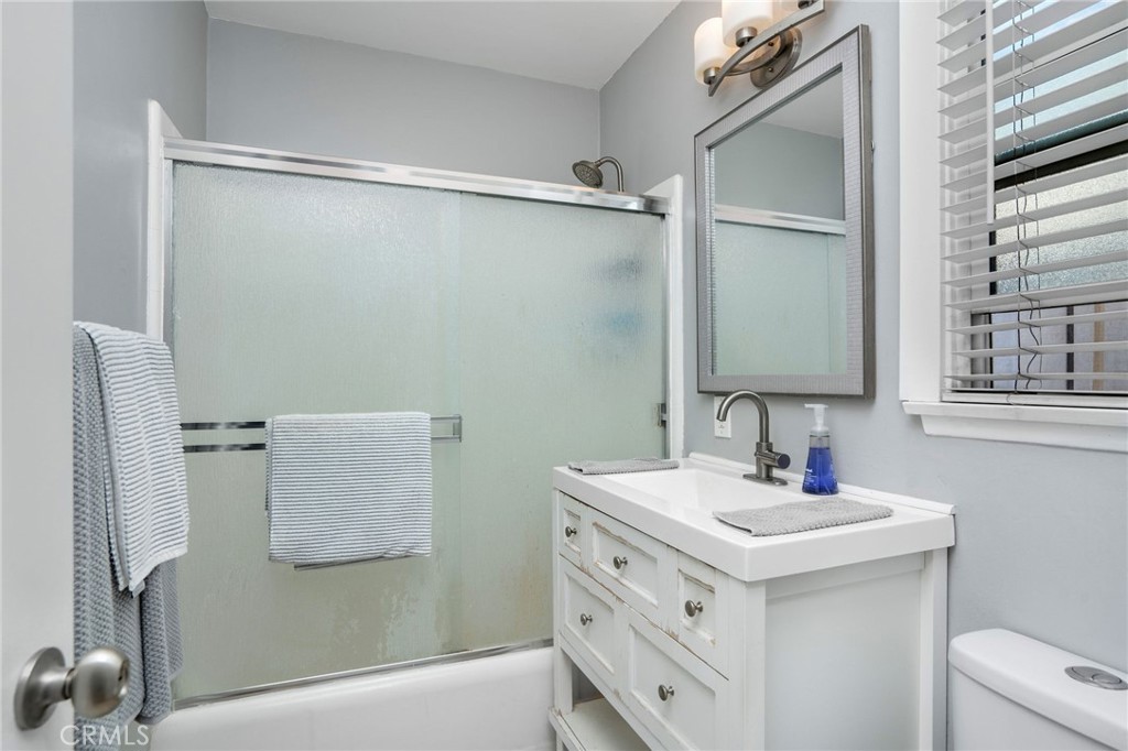 257 5th Street Seal Beach, CA 90740 - Photo 48 of 49 a bathroom with a sink vanity and mirror