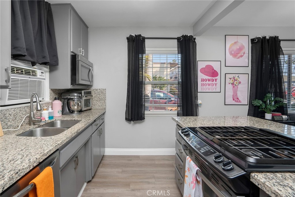 257 5th Street Seal Beach, CA 90740 - Photo 9 of 49 a kitchen with granite countertop a stove and a sink