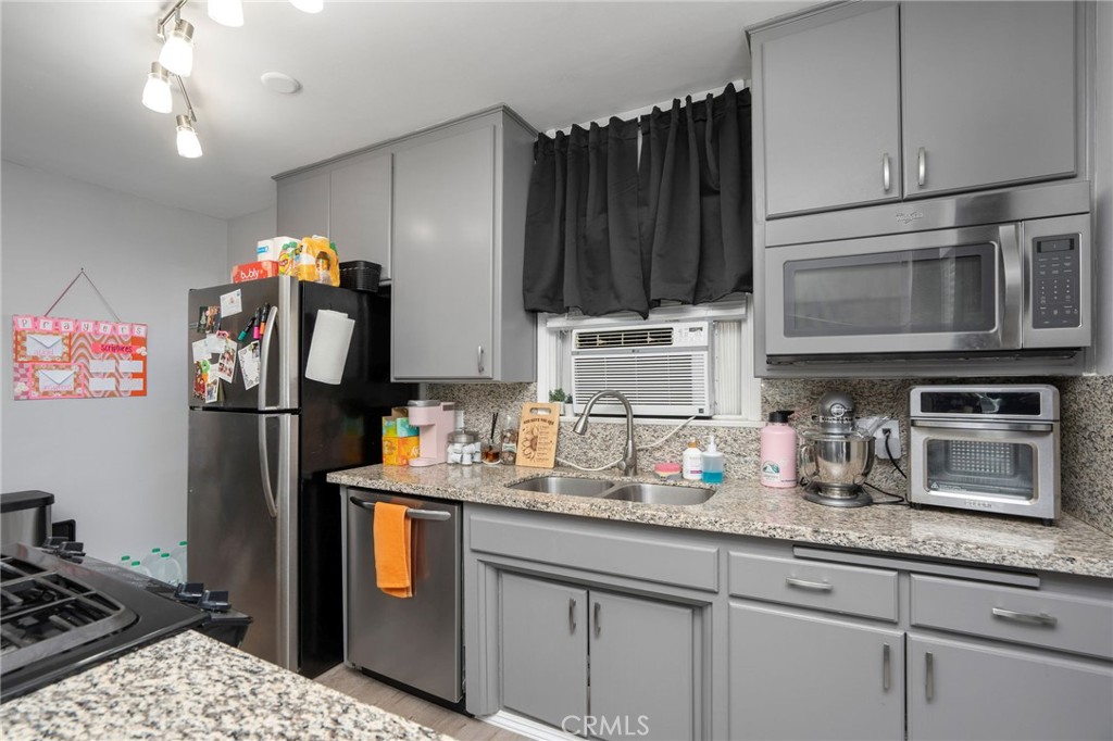 257 5th Street Seal Beach, CA 90740 - Photo 10 of 49 a kitchen with stainless steel appliances granite countertop a refrigerator stove and sink