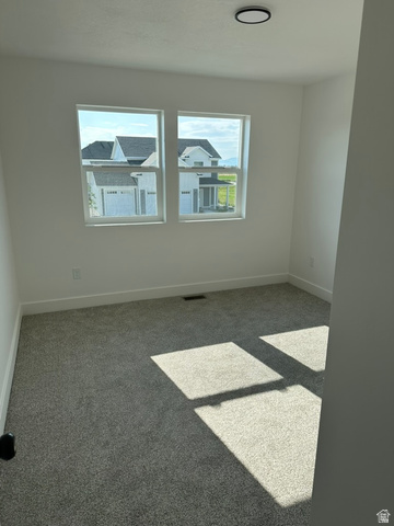 1886 North 300 West Logan, UT 84341 - Photo 13 of 18 Bright room with dual windows, new gray carpeting, white baseboards, and a contemporary flush-mount ceiling light