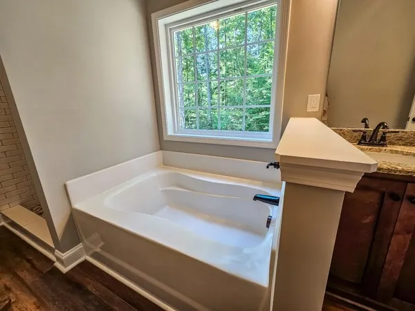a bathroom with a bathtub and a window