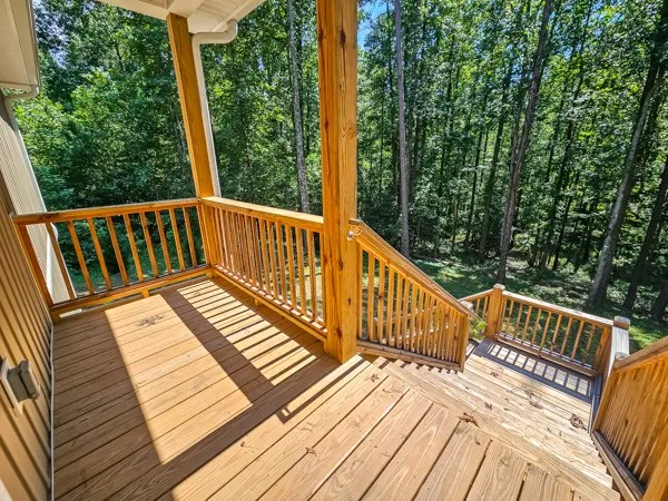 a view of balcony with wooden floor and fence