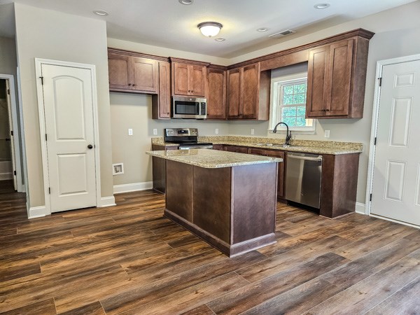 3177 Rodgers Creek Road Ellijay, GA 30540 - Photo 6 of 31 a kitchen with stainless steel appliances granite countertop a stove a sink dishwasher and a refrigerator with wooden floor
