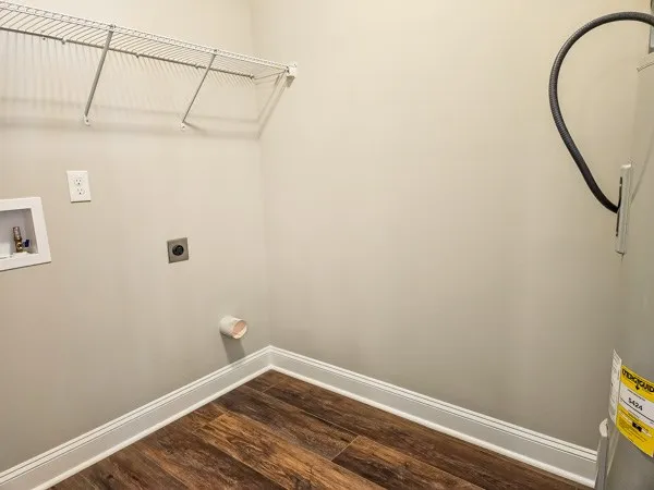 a view of a room with wooden floor and a window