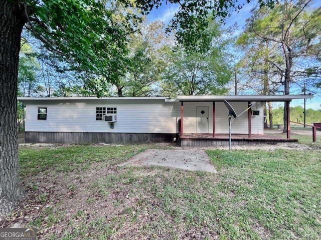 3195 Henderson Grove Road Sandersville, GA 31082 - Photo 18 of 50 a backyard of a house with wooden fence and large trees