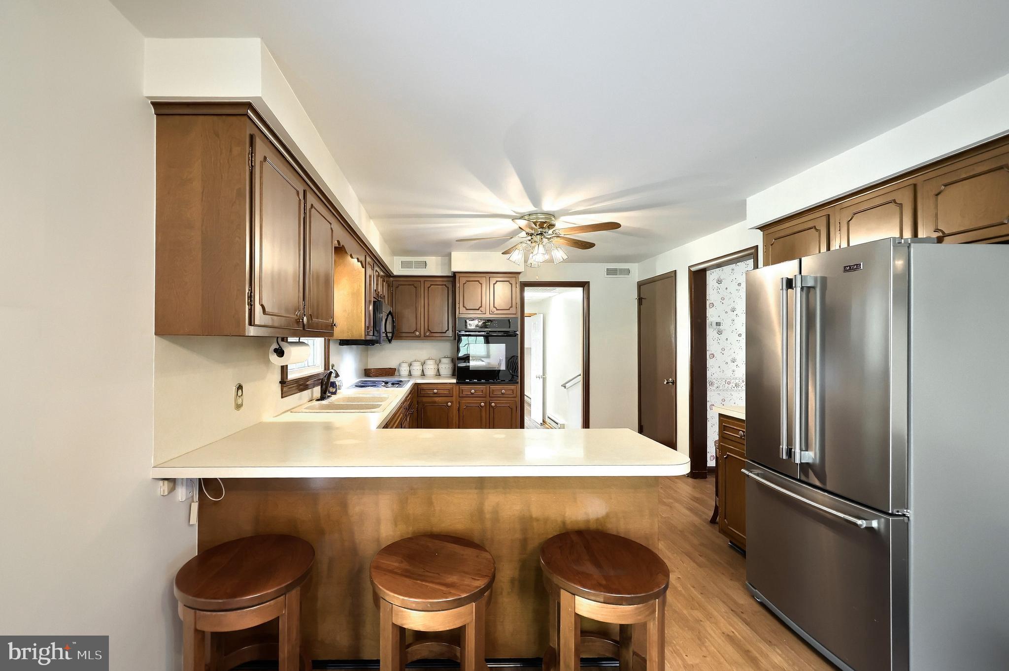 358 Three Hill Road Spring Grove, PA 17362 - Photo 11 of 50 a kitchen with a table chairs refrigerator and cabinets