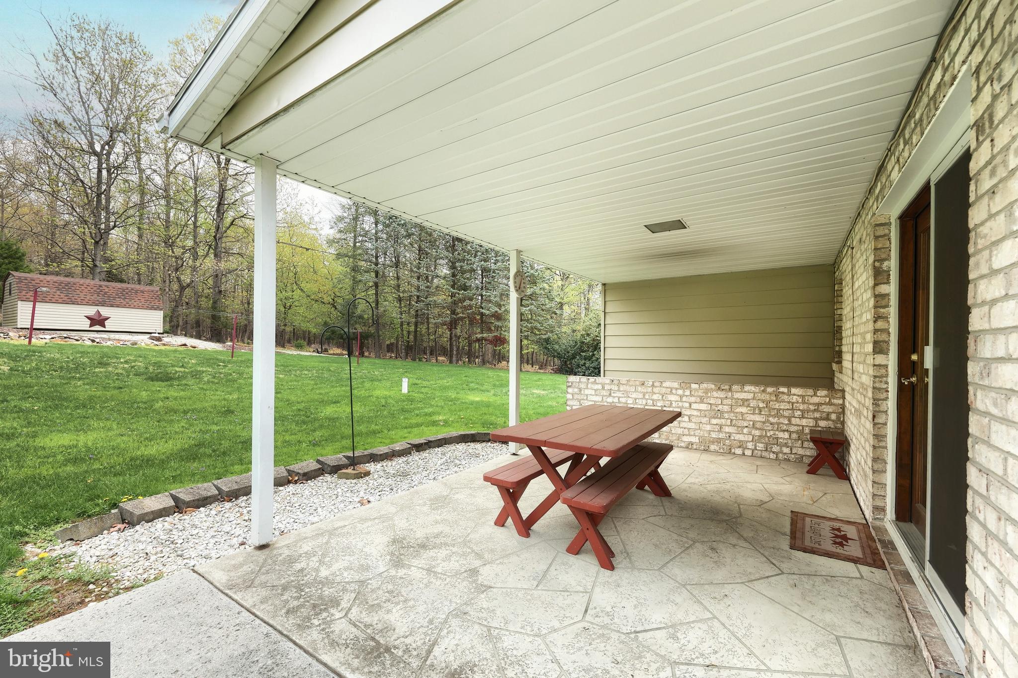 358 Three Hill Road Spring Grove, PA 17362 - Photo 42 of 50 a view of a patio with a table chairs and a backyard