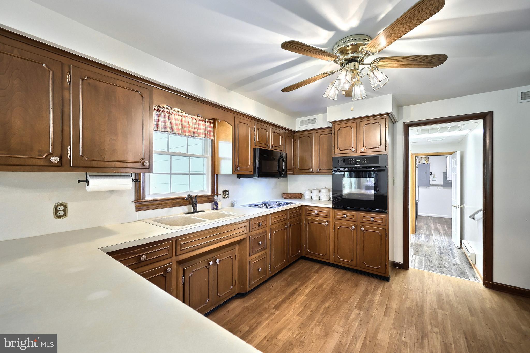 358 Three Hill Road Spring Grove, PA 17362 - Photo 8 of 50 a kitchen with stainless steel appliances hardwood floor sink stove and refrigerator