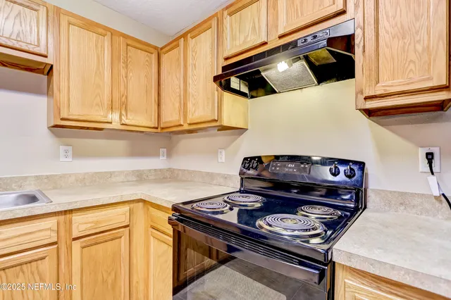 a view of a kitchen with granite countertop cabinets and stainless steel appliances