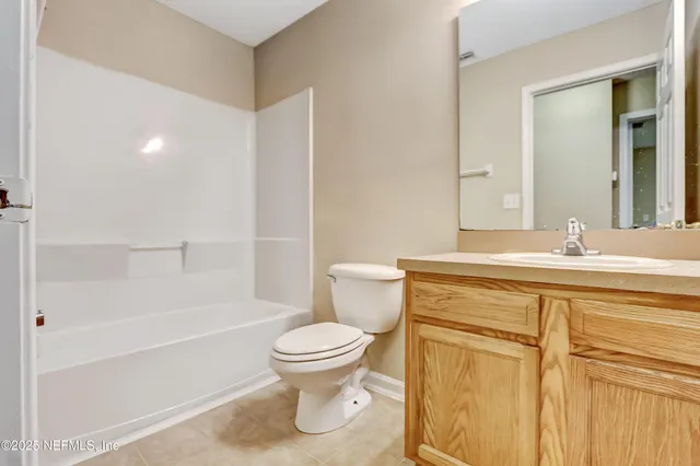 an empty room with closet and ceiling fan