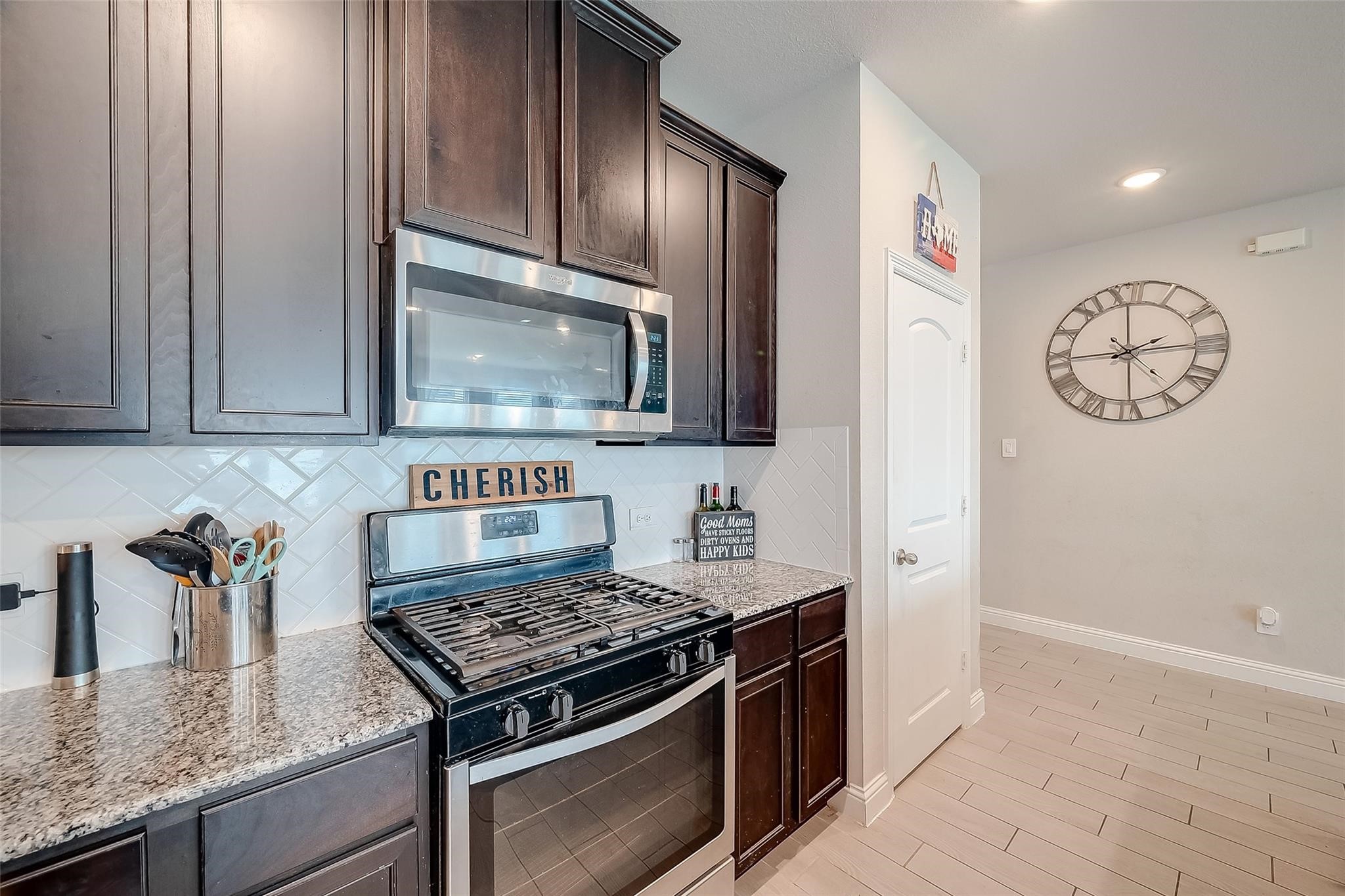 4731 Seabourne Landing Drive Rosenberg, TX 77469 - Photo 12 of 49 a kitchen with granite countertop cabinets and stove top oven