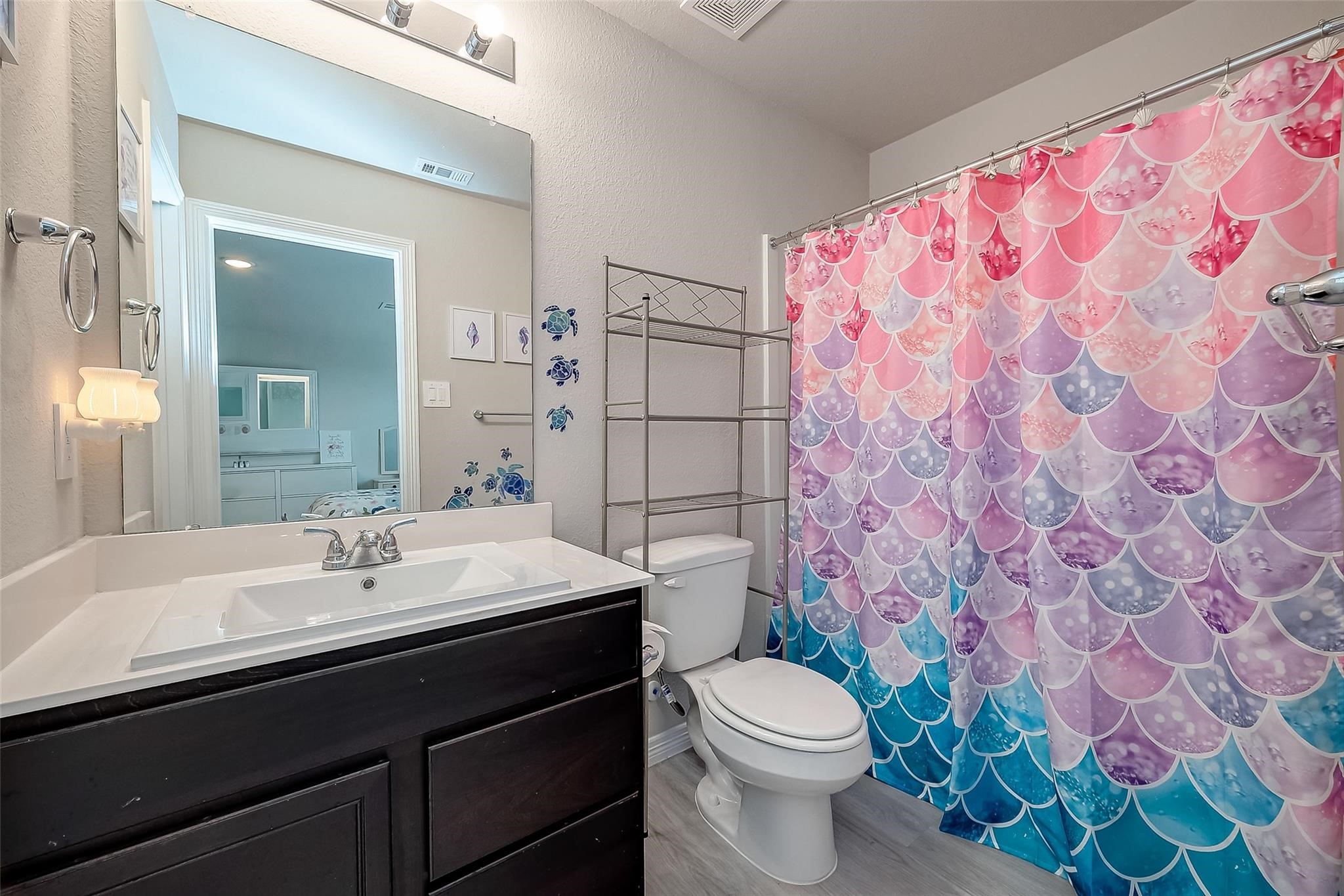 4731 Seabourne Landing Drive Rosenberg, TX 77469 - Photo 32 of 49 a bathroom with a sink a toilet and shower curtain