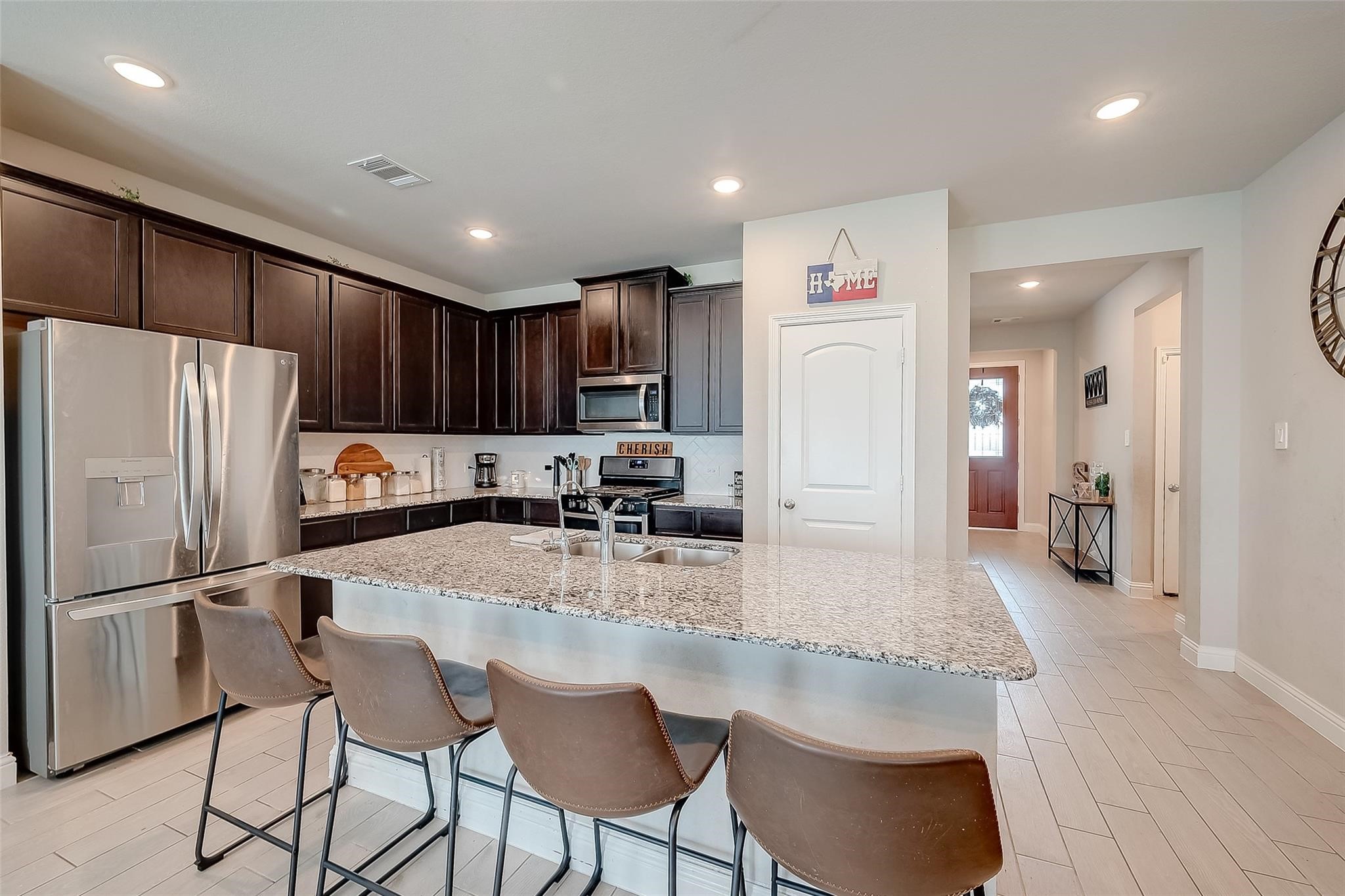 4731 Seabourne Landing Drive Rosenberg, TX 77469 - Photo 9 of 49 a kitchen with granite countertop a refrigerator and a stove top oven