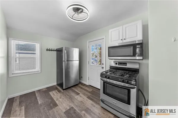 a kitchen with wooden cabinets and stainless steel appliances