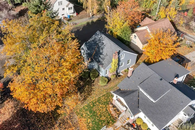 an aerial view of a house with a yard
