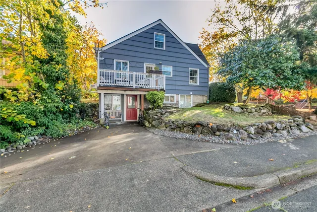a view of a house with a yard and trees