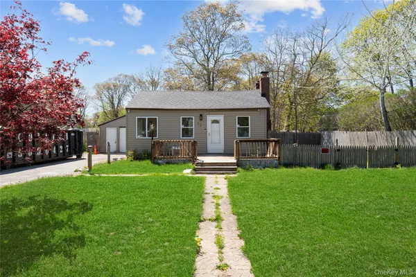 a front view of house with yard patio and green space
