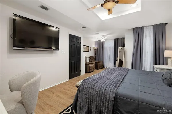 a bedroom with a bed and a flat screen tv