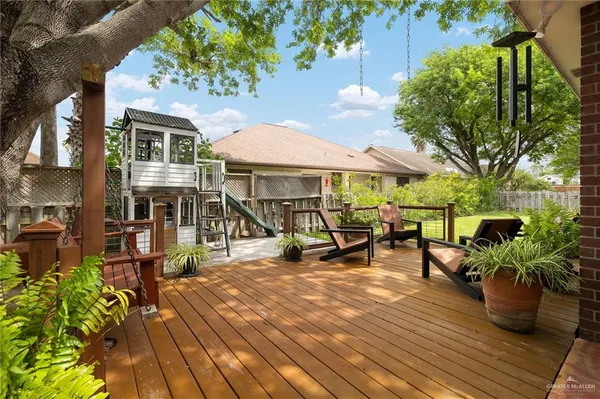 a view of a dinning table and chairs in the patio of the house