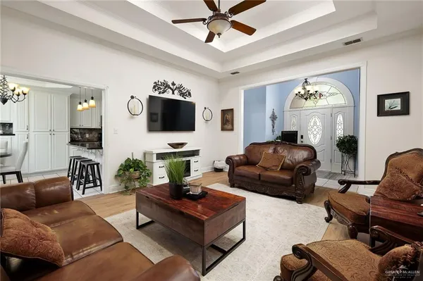 a living room with furniture a large window and a flat screen tv