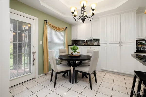 a view of a dining room with furniture wooden floor and chandelier