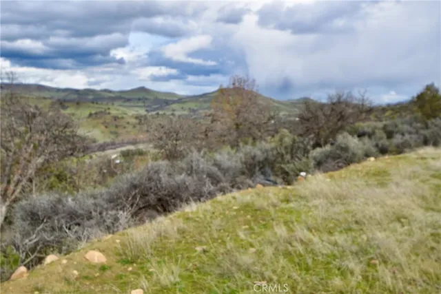 a view of a big yard with mountains in the background