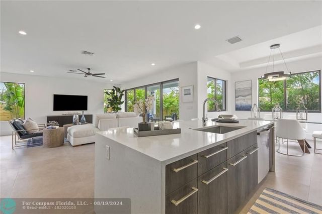 a kitchen with sink attached with living room
