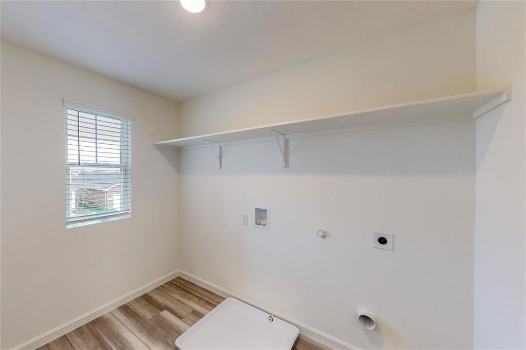 407 Madison Way Princeton, TX 75407 - Photo 12 of 40 Laundry room featuring hookup for a gas dryer, light wood finished floors, washer hookup, and electric dryer hookup